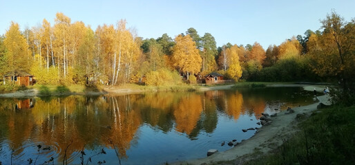 Autumn forest lake in Ural forest. Nature background. Copy space
