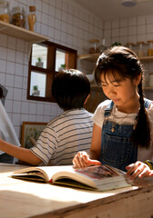 Family happy moments when children Helping mom cook food in the kitchen.