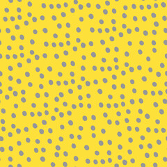 Seamless repeating spotted pattern with tiny hand drawn dots. Yellow vector background for surface design and other design projects