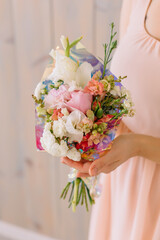 bride holding bouquet of roses