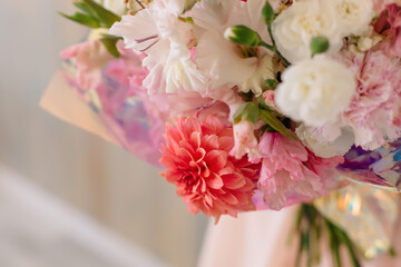 Pink chrysanthemums in a wedding bouquet with flowers on a background