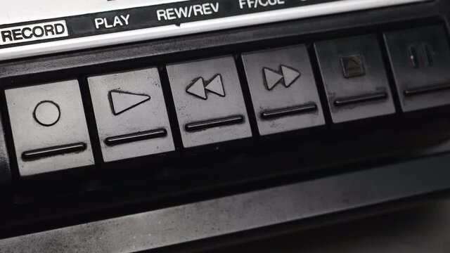 Pressing Stop Button On An Old Black Cassette Tape Recorder.
