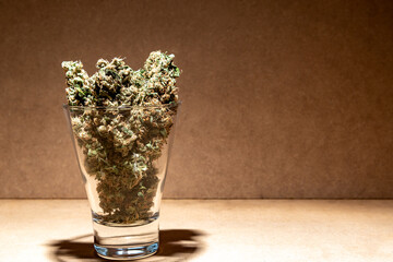 Details of some medical marihuana buds inside a glass. Selective focus.