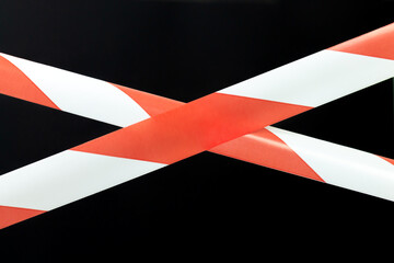 Red and white lines of barrier warning tape forbids passage, no entry