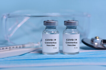 Medical bottles, vials,vaccine, syringe , face mask,body thermometer,stethoscope and protective glasses. The concept of medicine, healthcare and science.Coronavirus vaccine and immunity improvement.
