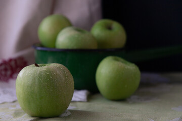 Fresh green apples in a green vintage bowl