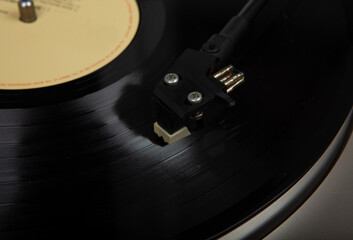 Closeup shot of a record stylus contacting with the surface of a vinyl