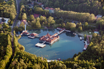 Top view of Lake Heviz, residential buildings and a park with green trees.