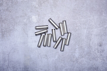 Batteries energy equipment on gray concrete background, top view space for text