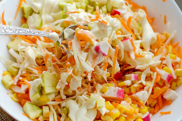 Chopped vegetables - cabbage, carrots, corn. Home cooked food.