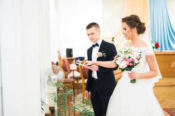 Bride and groom holding candles in church