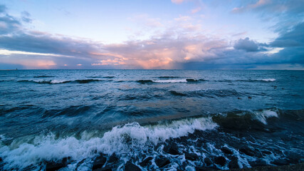 The rough sea and the sky in the colors of the setting sun