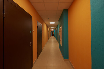 ypical ordinary corridor of a residential building, painted in bright colors, metal unnamed...
