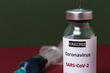 Transparent glass vials with test COVID-19 vaccine, with syringes
