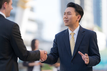 Close up, Handshake of two businessmen on the background of modern office, partnership concept