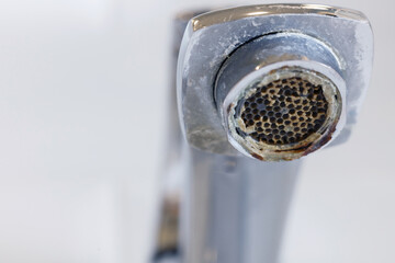 Limescale on faucet mesh in the bathrooms. Close up view