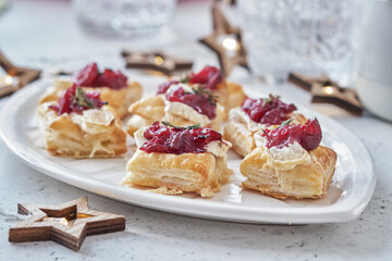 Holiday appetizers with cranberry sauce, brie cheese and thyme
