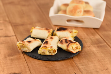 Appetizing filled bread rolls on a slate plate.
