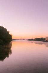 dawn over a misty river