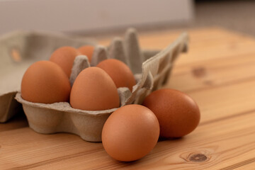 eggs in a package on a wooden table