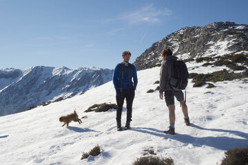 two young mountaineers look at the map in the middle of nine next to their mascots