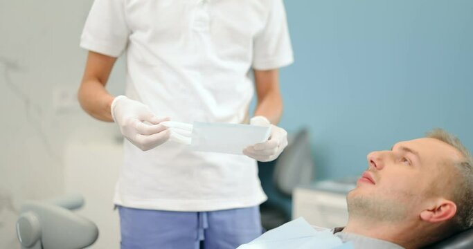 Dentist getting optragate, preparing for the dental checkup. Patient with dental braces during a regular visit to the orthodontist