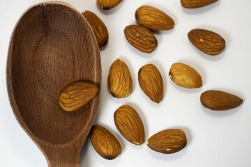 nuts in spoon on white isolated background with copy space