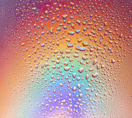 Background of drops of water on multicolor surface .
