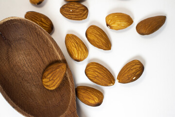 nuts in spoon on white isolated background with copy space