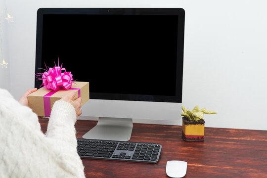 Mockup Of A Black Computer Screen And A Person Delivering A Gift In Front Of The Computer.