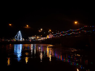 Christmas lights reflecting on river