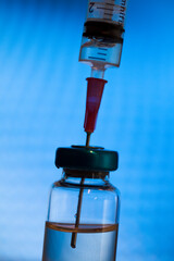 Close up of a medical injection needle in a vaccine vial dose