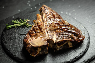 Medium rare Grilled T-Bone Steak, Barbecue aged wagyu porterhouse juicy steak rare beef with spices on dark background. Food recipe background. Close up