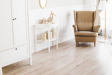 Obraz premium light interior with a brown armchair with a white table and wardrobe