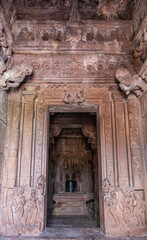 Fototapeta na wymiar Bagalakote, Karnataka, India - November 7, 2013: Pattadakal temple complex. Inside sanctum of Jambulingeshwara temple. All surfaces covered by sculptures, Shivalingam on yoni in its inner sanctum.