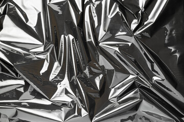 Plastic wrap. Black shiny film bag pattern. Transparent dark cellophane texture. Creative crumpled...
