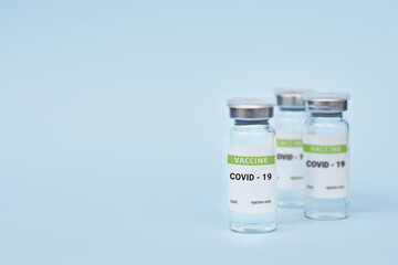 Three cans of coronavirus vaccine. on a blue background. copy space, banner