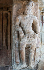 Bagalakote, Karnataka, India - November 7, 2013: Pattadakal temple complex. Closeup of gray stone statue of dwarapalaka at entrance to Virupaksha temple.