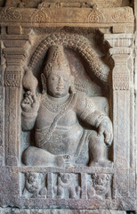 Bagalakote, Karnataka, India - November 7, 2013: Pattadakal temple complex. Closeup of gray stone statue of obese wealth symbol at entrance to Virupaksha temple.