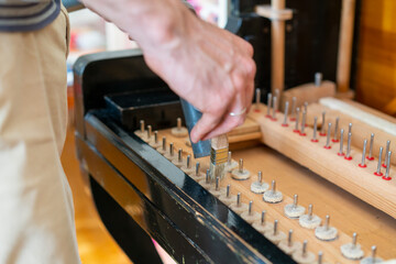 Setting up an old piano. The master repairs an old piano. Deep cleaning the piano. Hands of professional worker repairing and tuning an old piano. toned