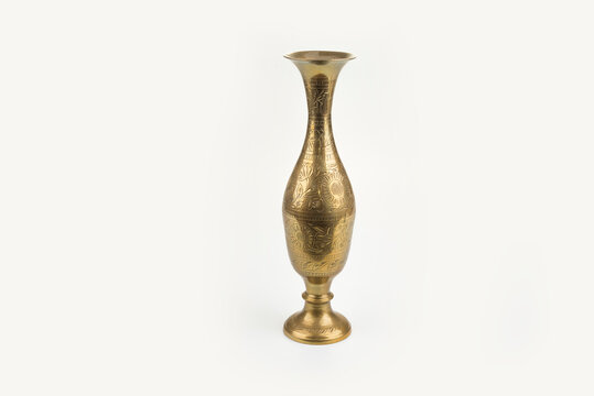 Gold metal carving vase on a white