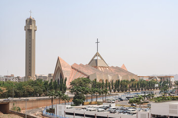 National Ecumenical center, a Christian building for religious ceremonies, in modern architecture style with spiked roof and cross shaped bell tower in Abuja, Federal Capital Territory, Nigeria - obrazy, fototapety, plakaty