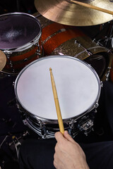 Obraz premium Professional drum set closeup. Man drummer with drumsticks playing drums and cymbals, on the live music rock concert or in recording studio &nbsp;