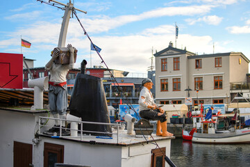Two pirate figures rest on the deck of a tourist boat in the Alter Strom Canal in the Baltic Sea...