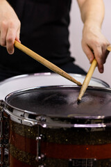 Professional drum set closeup. Man drummer with drumsticks playing drums and cymbals, on the live music rock concert or in recording studio   