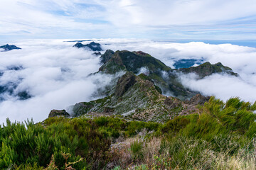 Above the clouds on the mountain peak Pico Ruivo towards the opposite peak Achada do Teixeira on...