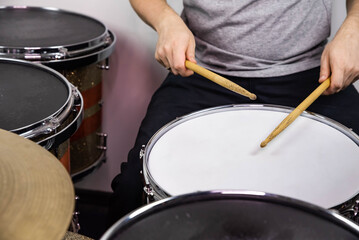 Obraz premium Professional drum set closeup. Man drummer with drumsticks playing drums and cymbals, on the live music rock concert or in recording studio &nbsp;