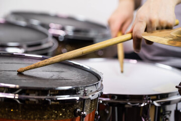Professional drum set closeup. Man drummer with drumsticks playing drums and cymbals, on the live music rock concert or in recording studio   