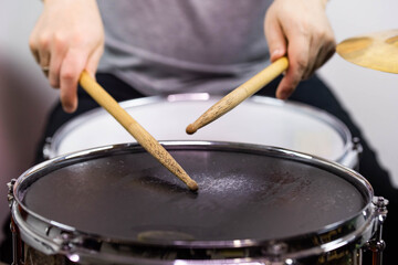 Professional drum set closeup. Man drummer with drumsticks playing drums and cymbals, on the live music rock concert or in recording studio   