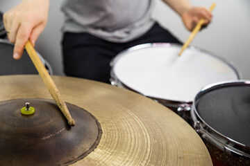 Professional drum set closeup. Man drummer with drumsticks playing drums and cymbals, on the live music rock concert or in recording studio  &nbsp;